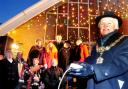 LIT UP: Pendle mayor Tony Beckett turns on the lights as the crowd listens to the Salvation Army band