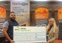 Ben Smithson awards a donation to Blackburn and Darwen Youth Zone's Melanie Thomas