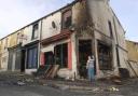 WRECKED Burnt and looted grocery shop