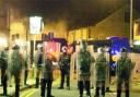 FRIGHTENING TIMES Riot police line the streets of Burnley.