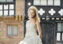 DRESS TO IMPRESS Nicola Wood outside Turton Tower which is now to host weddings. The dress was donated by Ninety One wedding shop, Bury. Picture: Robert Binder