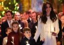 Princess Charlotte, Prince Louis and the Princess of Wales hold candles during the Royal Carols - Together At Christmas service at Westminster Abbey in London