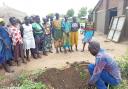 An agricultural officer demonstrates the planting of trees to people from the Diocese of Liwolo in Southern Sudan