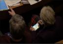 Cllr Lishman apparently playing Candy Crush on her mobile phone in a council meeting