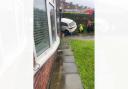 The car became wedged between a house and a fence in Cherry Tree, Blackburn