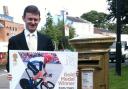 Chorley council deputy leader Councillor Peter Wilson, with the Bradley Wiggins stamp and gold postbox.