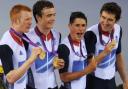 Ed Clancy (left), Geraint Thomas (right), Steven Burke (second left) and Peter Kennaugh celebrate with their Gold medals