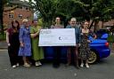 A North West Subaru owners’ club has handed over £1,000 to a charity supporting people living with dementia and their families.