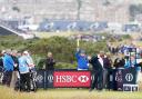 ILLUSTRIOUS COMPANY: Clitheroe’s Mark Young (left) watches Justin Rose tee off at St Andrews yesterday