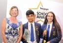 Headboy and girl Kasom Shah and Katie Lister collect last year's Head Teacher of the Year Award on behalf of Richard Varey of Blessed Trinity RC College, Burnley, from Jane Scott
