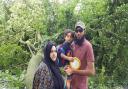 Shezmeen Munshi, Azaz Chanda and their son Mousa Chanda infront of the large trunk that almost crashed onto their car in East Park Road, Blackburn