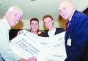 GRATEFUL: Bay Horse landlord Alex Hawthorne signs the cheque, watched by, from the left, Sam Litherland, Christian Gillibrand and Les Hardy, of the North West Air Ambulance Service