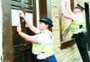 SHUT DOWN: PCSO Catherine Clough and PC John Fisher serve the closure order on the house in Reed Street, Burnle