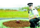 THEFT: PC Phil Hambley inspects the spot the roundabout stood before it was stolen