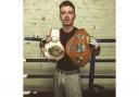 Earby boxer Josh Holmes with his two Yorkshire title belts.