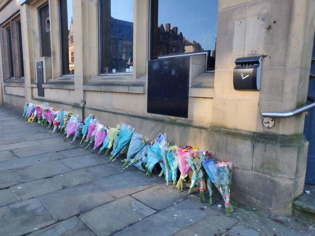 Lancashire Telegraph: Floral tributes have been left outside Sunbird Records for Jonathan Lindley, who died on Tuesday 
