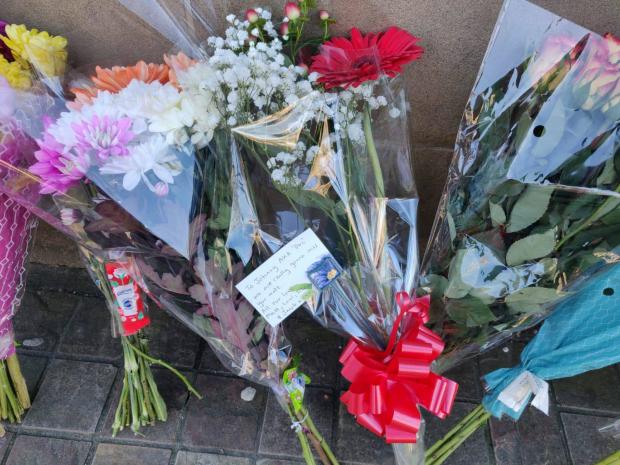 Lancashire Telegraph: Floral tributes have been left outside Sunbird Records for Jonathan Lindley, who died on Tuesday 