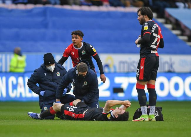 Rovers captain Darragh Lenihan receives treatment in the FA Cup tie at Wigan