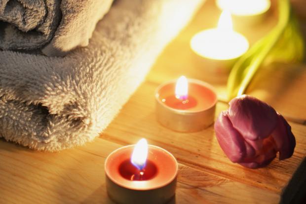 Lancashire Telegraph: A pile of towels, candles and a tulip. Credit: Canva