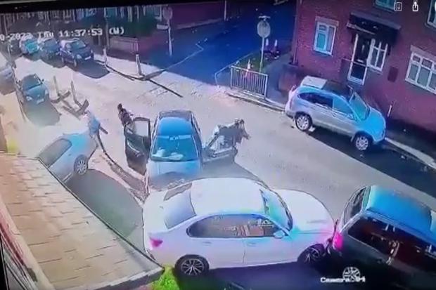 Footage shows three men running from a car after crashing it at the junction of Holly Street and Cedar Street in Blackburn