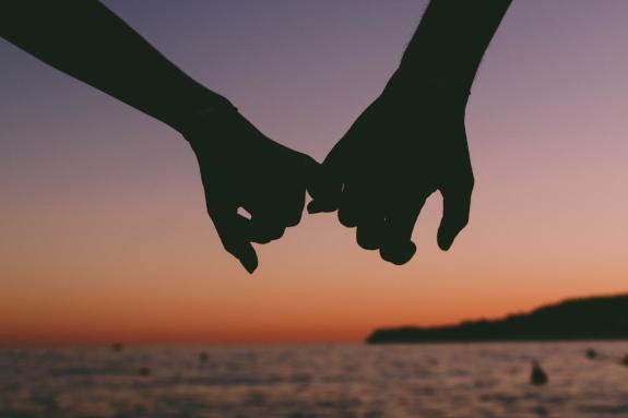 Lancashire Telegraph: A couple linking fingers as they walk by the sea. Credit: Canva Lancashire Telegraph: A couple linking fingers as they walk by the sea. Credit: Canva