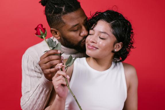 Lancashire Telegraph: A man giving his partner a red rose. Credit: Canva Lancashire Telegraph: A man giving his partner a red rose. Credit: Canva