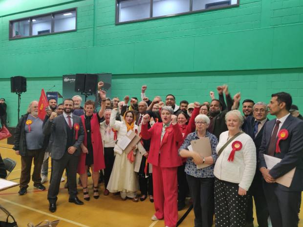 Lancashire Telegraph: The Labour party celebrating after holding all their seats in Burnley council