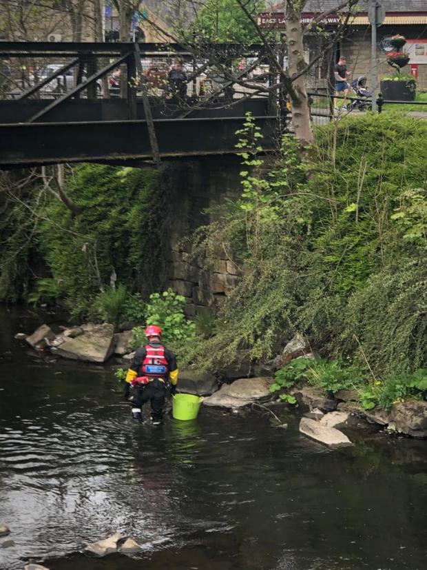 Lancashire Telegraph: Teams spent three hours in the water clearing it of rubbish. Photo credit: Rossendale and Pendle Mountain Rescue Team