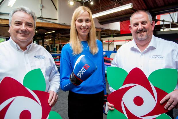 Lancashire Telegraph: The directors launching the new logo’s icon at Love Boxing ABC in Rossendale. From left - John Cooper (Interfloor CEO), Sarah Walton (Active Lancashire Director of Business) and Gary McEwan (Interfloor HR Director).