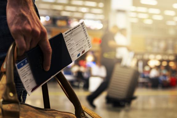 Lancashire Telegraph: A person holding luggage and their ticket. Credit: Canva Lancashire Telegraph: A person holding luggage and their ticket. Credit: Canva
