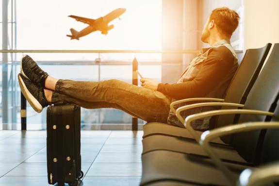 Lancashire Telegraph: A man looking at a plane taking off as he waits in the airport. Credit: Canva Lancashire Telegraph: A man looking at a plane taking off as he waits in the airport. Credit: Canva