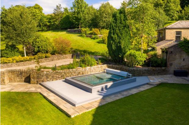 Lancashire Telegraph: The property's outdoor area with pool. (Photo: Savills)