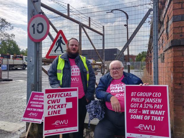 Lancashire Telegraph: An engineer, Rob and retired BT worker Maurice holding a picket line outside the site on Sumner Street