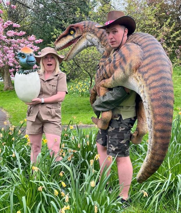 Lancashire Telegraph: BLC staff Andrea Pollard and Darrel Lamont show off some of the dinosaurs the children will encounter this summer.