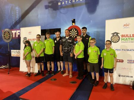 Lancashire Telegraph: Keith Brunt and members of the Blackburn Youth Darts Academy with Gerwyn Price