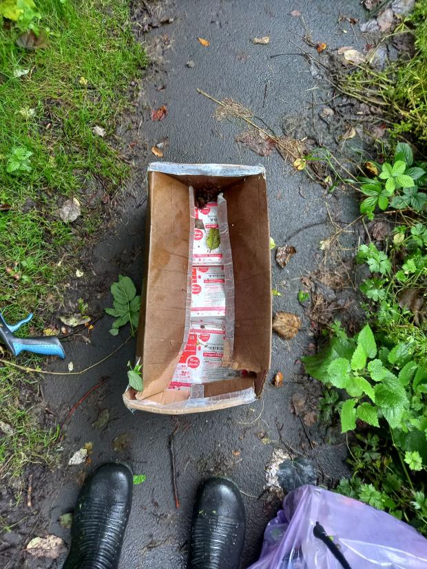 Lancashire Telegraph: Box of charity bags that was found dumped in a bush in Tinder Brook