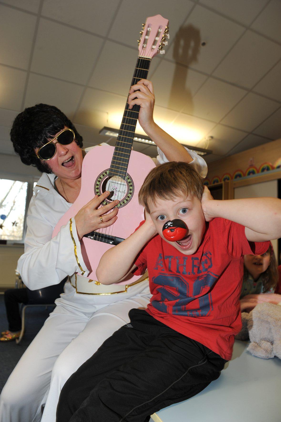 Bradley Middleton suffers Elvis tones from Sandra Quinn in Padiham Green Primay School.