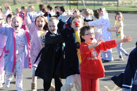 Staff and pupils from Worsthorne Primary School conga round the playground for Comic Relief.