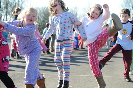 Staff and pupils from Worsthorne Primary School conga round the playground for Comic Relief.