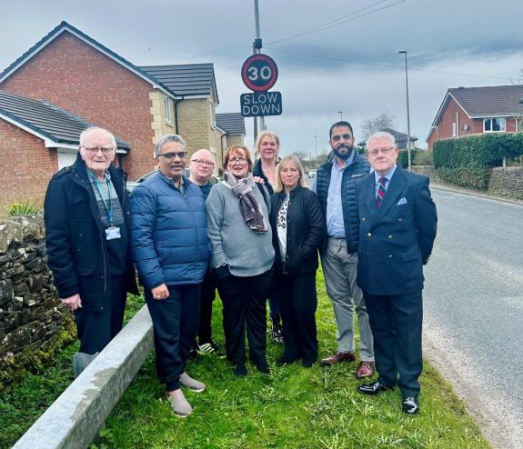 Lancashire Telegraph: Councillors and Guide residents stand with the new speed sign Lancashire Telegraph: Councillors and Guide residents stand with the new speed sign