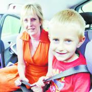 SAFETY:  FIRST: Blackburn with Darwen Casualty Reduction Team manager Claire Waterhouse,who is supporting the Lancashire Telegraph ‘Belt Them In!’ campaign, fastens her son, Michael, five, into his child’s car seat
