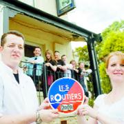 PRIDE OF PLACE: David and Jean Whiteside celebrate their Les Routiers award with staff looking on