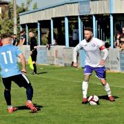 Tom Kennedy looks to set up another attack for Ramsbottom United against Ossett United