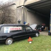 A mystery man has set up home under the motorway bridge at Darwen Services, leaving residents puzzled about why he's chosen that precise location