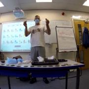 Bruce in the class showing some of the items he and his group have found while they have been out exploring
