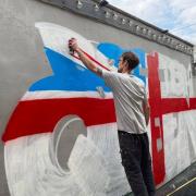 Keiron 'Curly' Whitehead, Darwen's resident grafitti artist has painted a huge Union Jack on the side of the British Queen's beer garden ready for the pub's re-opening on May 17