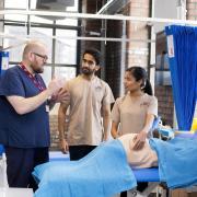A tutor teaching some students at the Burnley-based medical institute