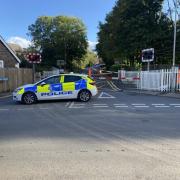 Road closed in both directions after car hits level-crossing barrier
