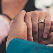 A woman wearing an engagement ring. Credit: Canva