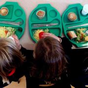 Photo via PA shows children eating school meals.